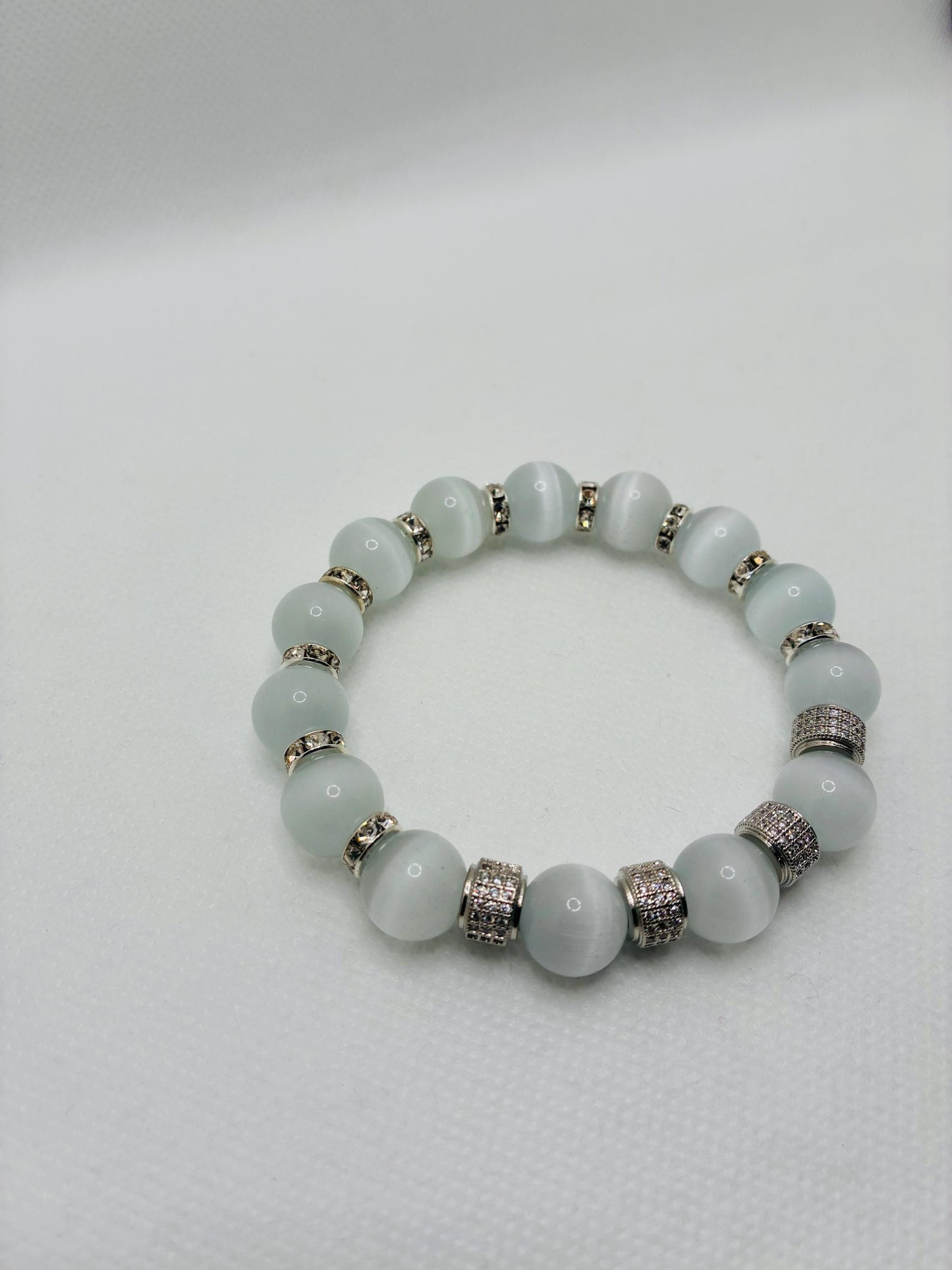 White Cats Eye Bracelet with Silver Zirconia Barrel Beads: Silverplated rhinestone rondelles