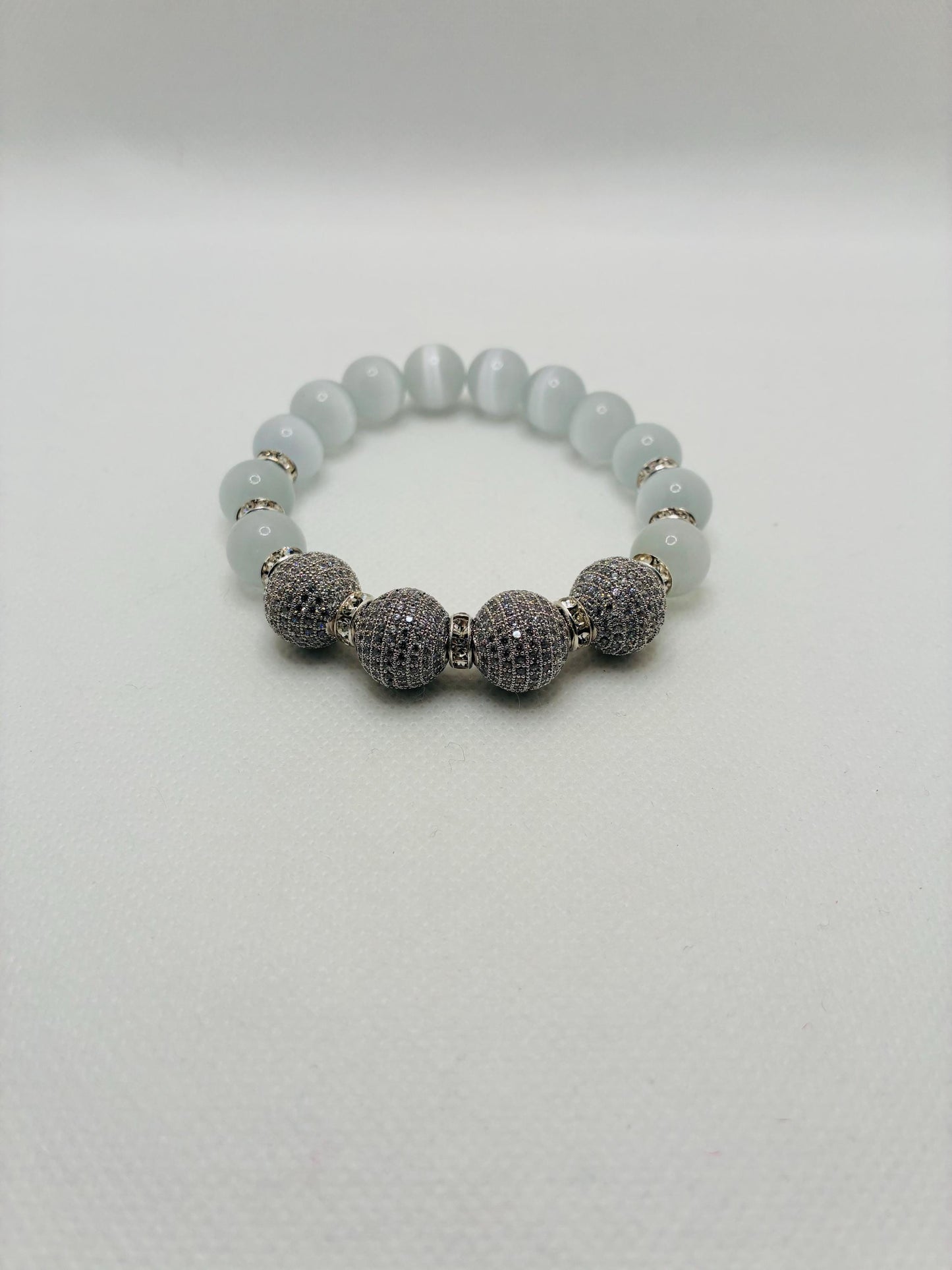 White Cats Eye Beaded Bracelet with Silver Cubic Zirconia Beads: Silverplated rhinestone rondelles