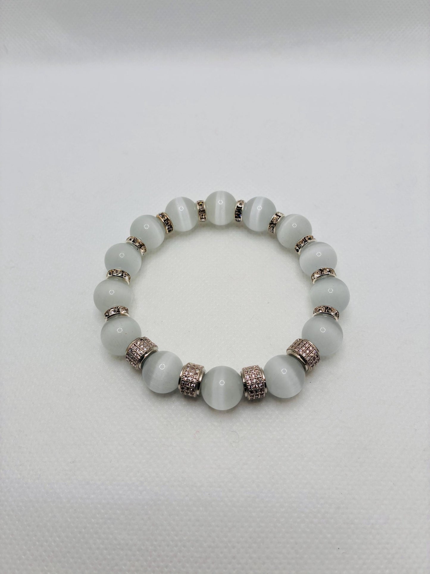 White Cats Eye Bracelet with Silver Zirconia Barrel Beads: Silverplated rhinestone rondelles
