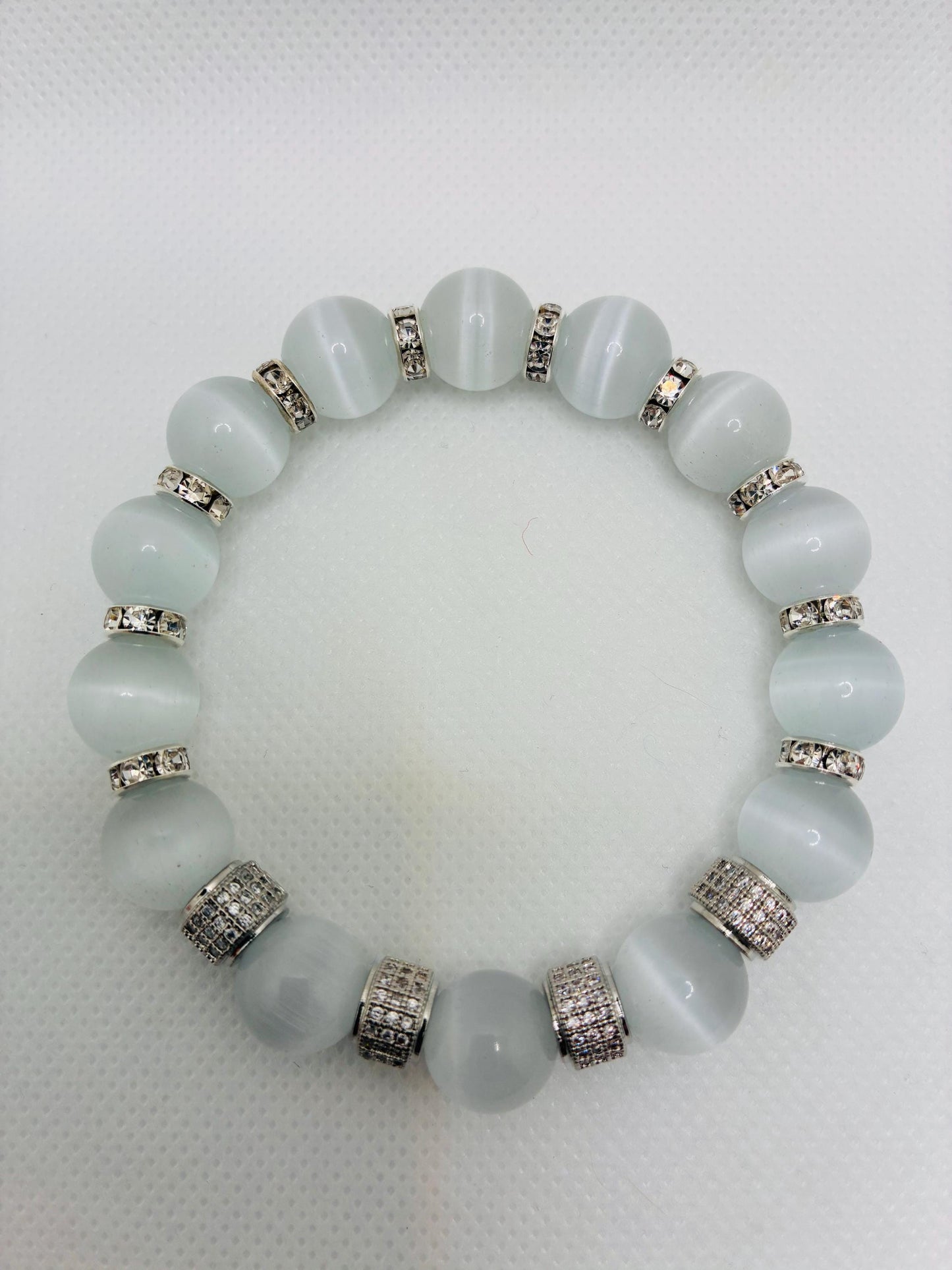 White Cats Eye Bracelet with Silver Zirconia Barrel Beads: Silverplated rhinestone rondelles