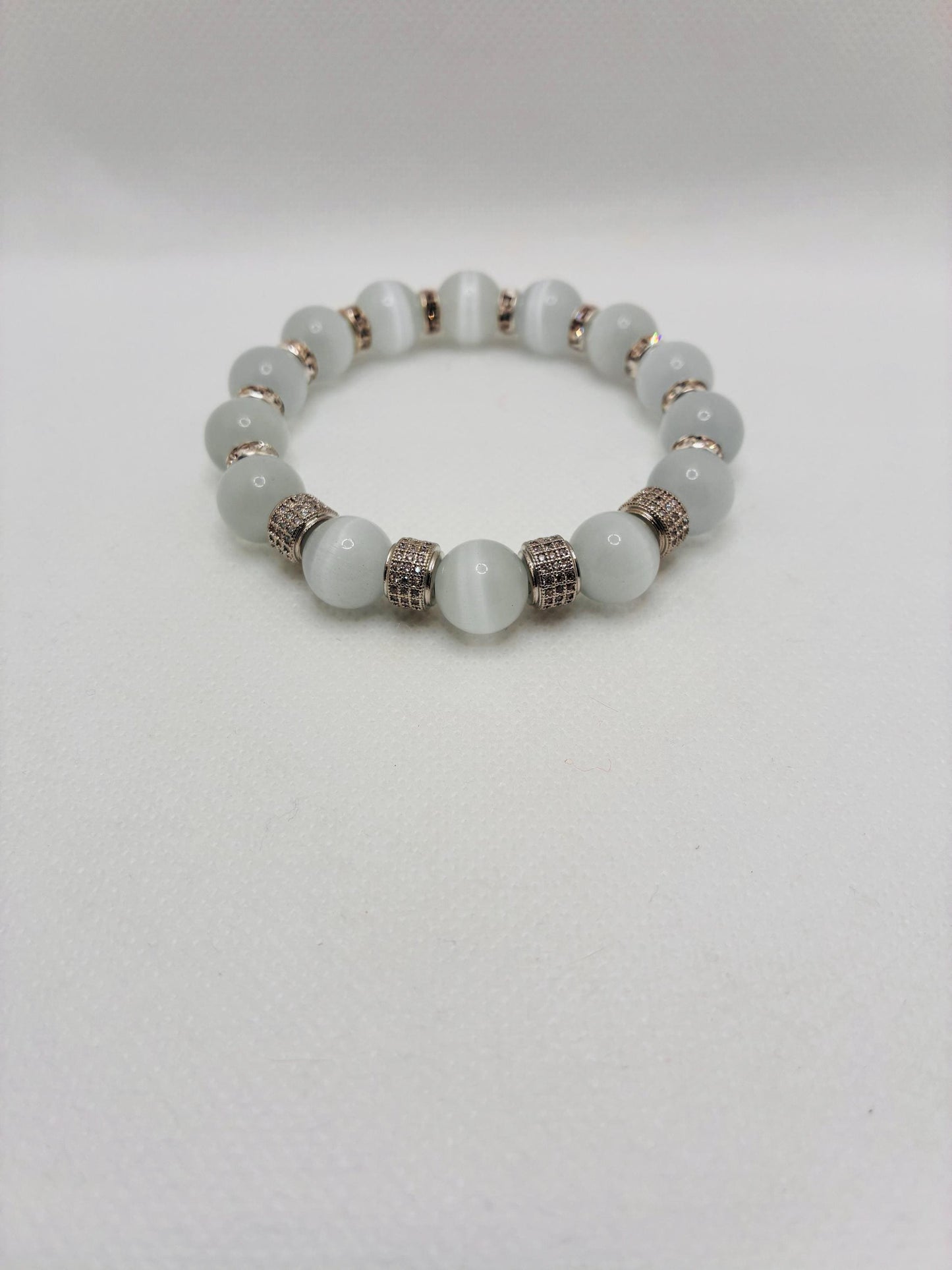 White Cats Eye Bracelet with Silver Zirconia Barrel Beads: Silverplated rhinestone rondelles