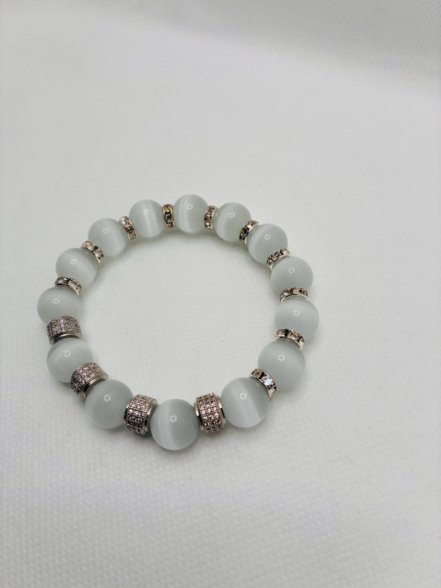 White Cats Eye Bracelet with Silver Zirconia Barrel Beads: Silverplated rhinestone rondelles