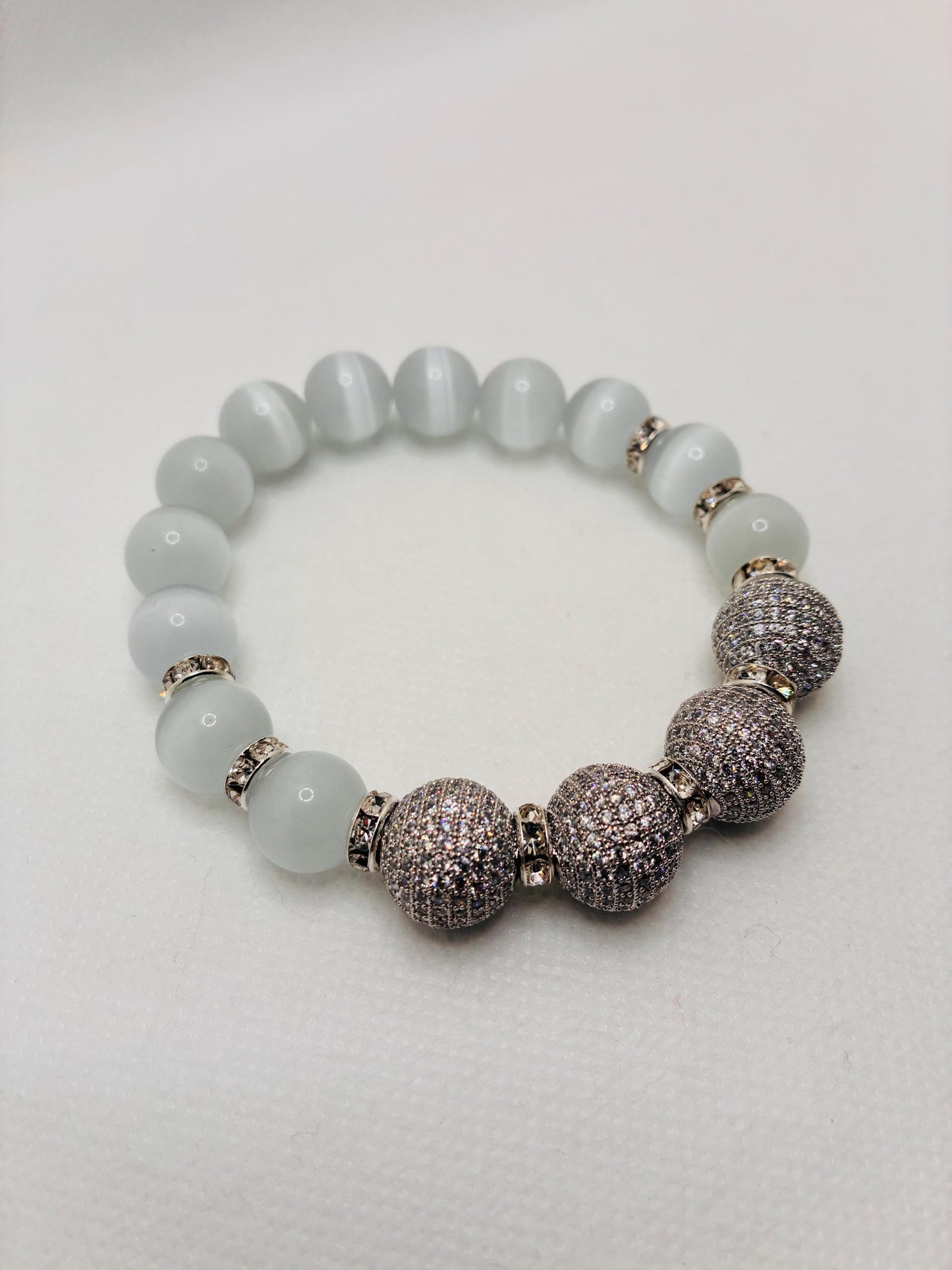 White Cats Eye Beaded Bracelet with Silver Cubic Zirconia Beads: Silverplated rhinestone rondelles