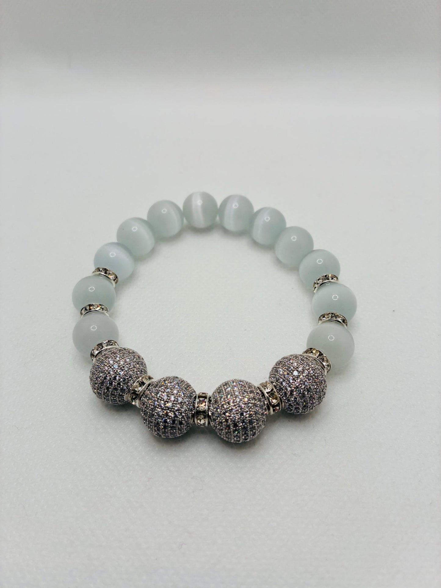 White Cats Eye Beaded Bracelet with Silver Cubic Zirconia Beads: Silverplated rhinestone rondelles