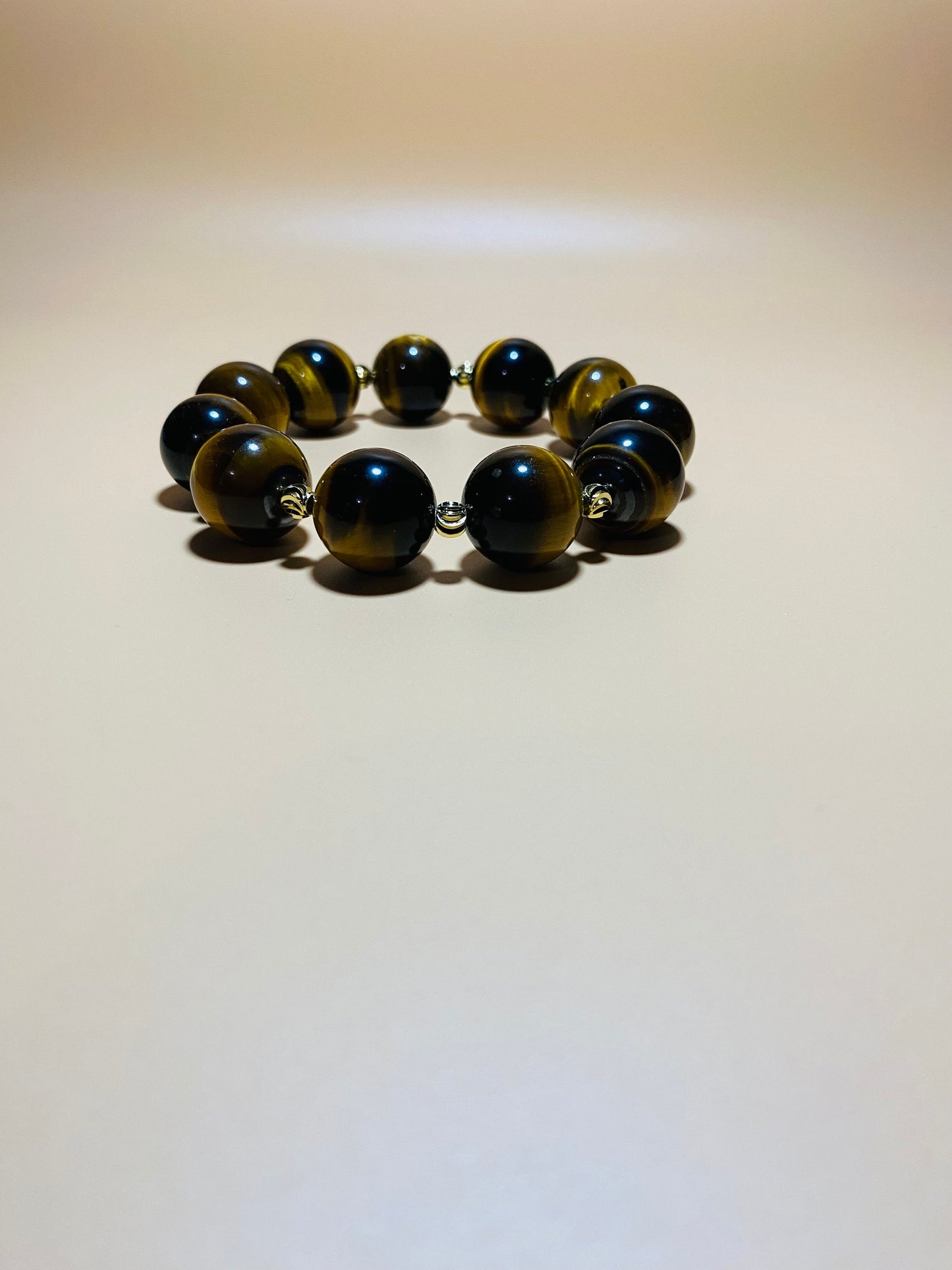 Tigers Eye Gemstone Bracelet: 16mm Beads with Gold Spacers