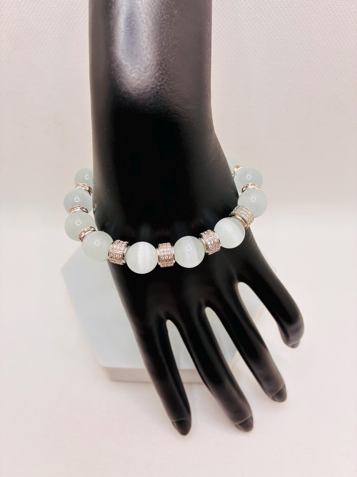 White Cats Eye Bracelet with Silver Zirconia Barrel Beads: Silverplated rhinestone rondelles