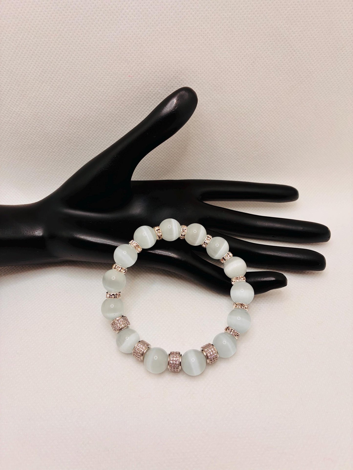 White Cats Eye Bracelet with Silver Zirconia Barrel Beads: Silverplated rhinestone rondelles