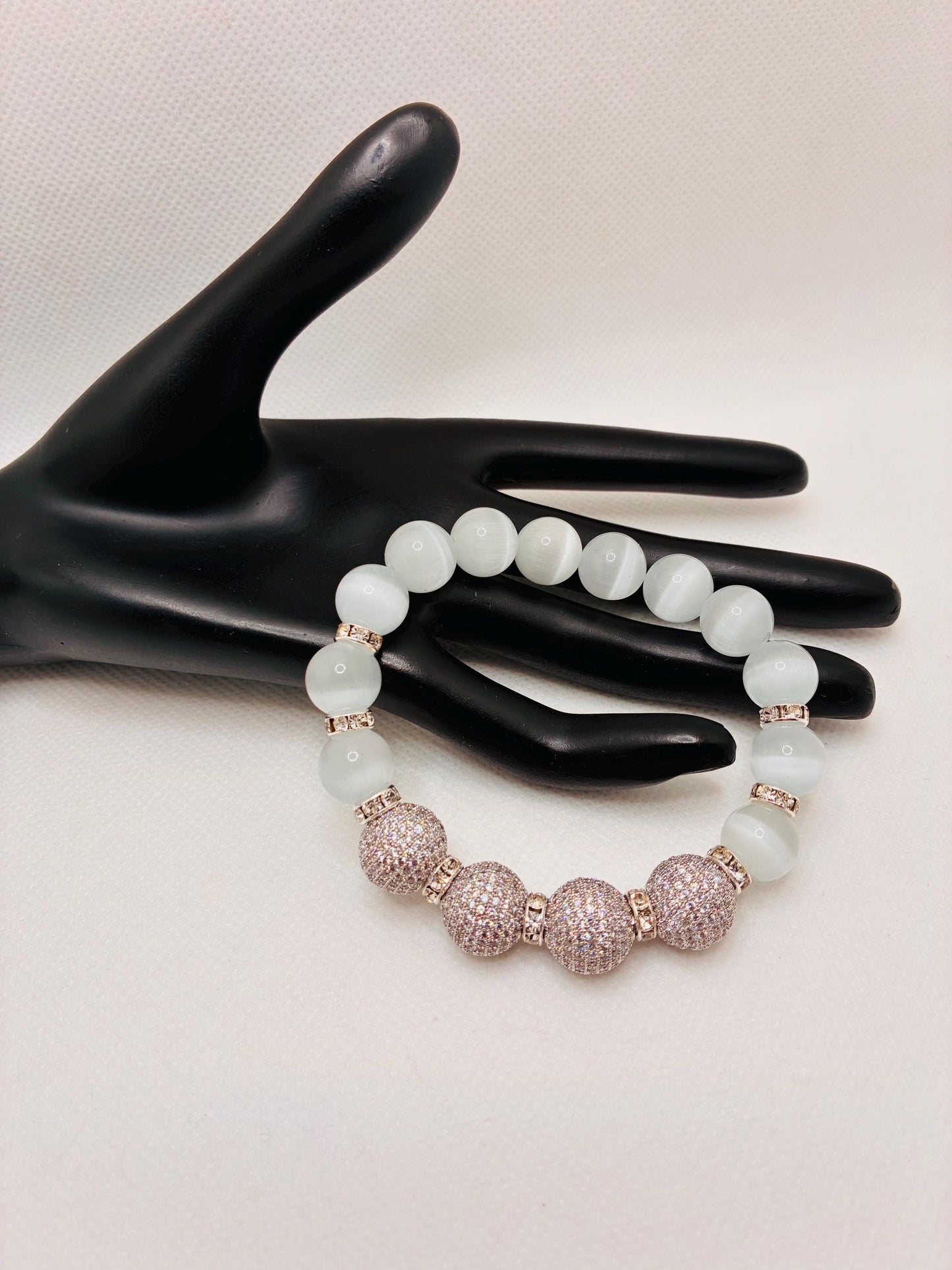 White Cats Eye Beaded Bracelet with Silver Cubic Zirconia Beads: Silverplated rhinestone rondelles