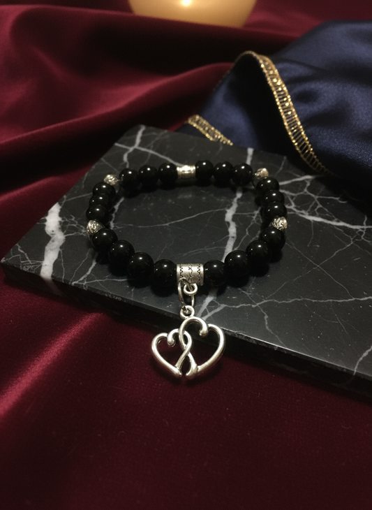 Enhanced background for Black Tourmaline Bracelet with Intertwined Heart Charm